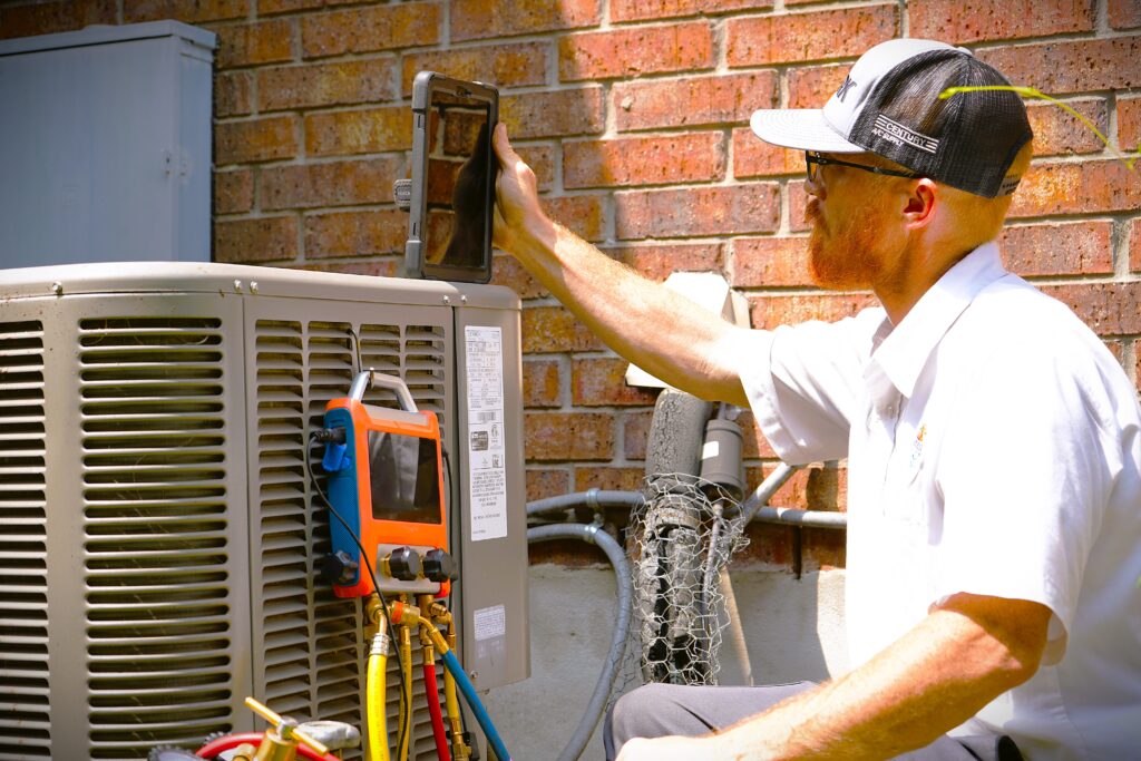 Dilmak Services technician testing a home air conditioner in San Antonio